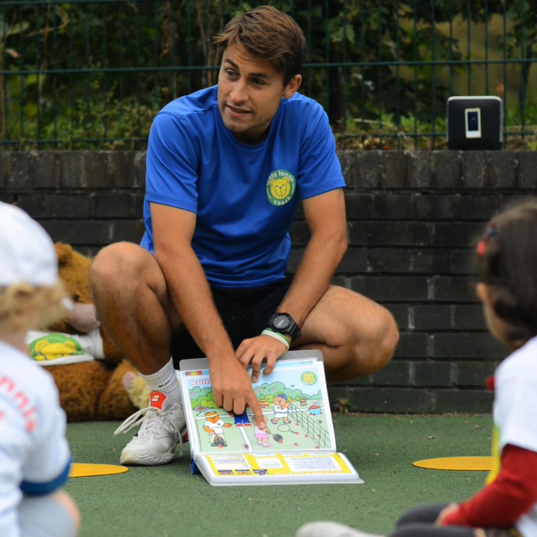 Teddy Tennis teacher showing kids the pictures