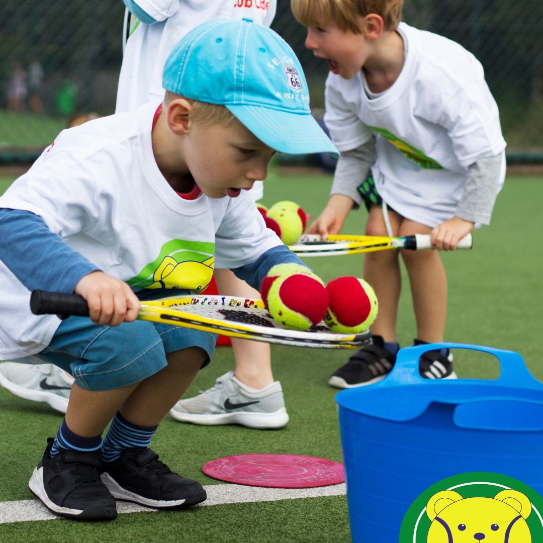 Young boy balancing Teddy Tennis balls on his racket