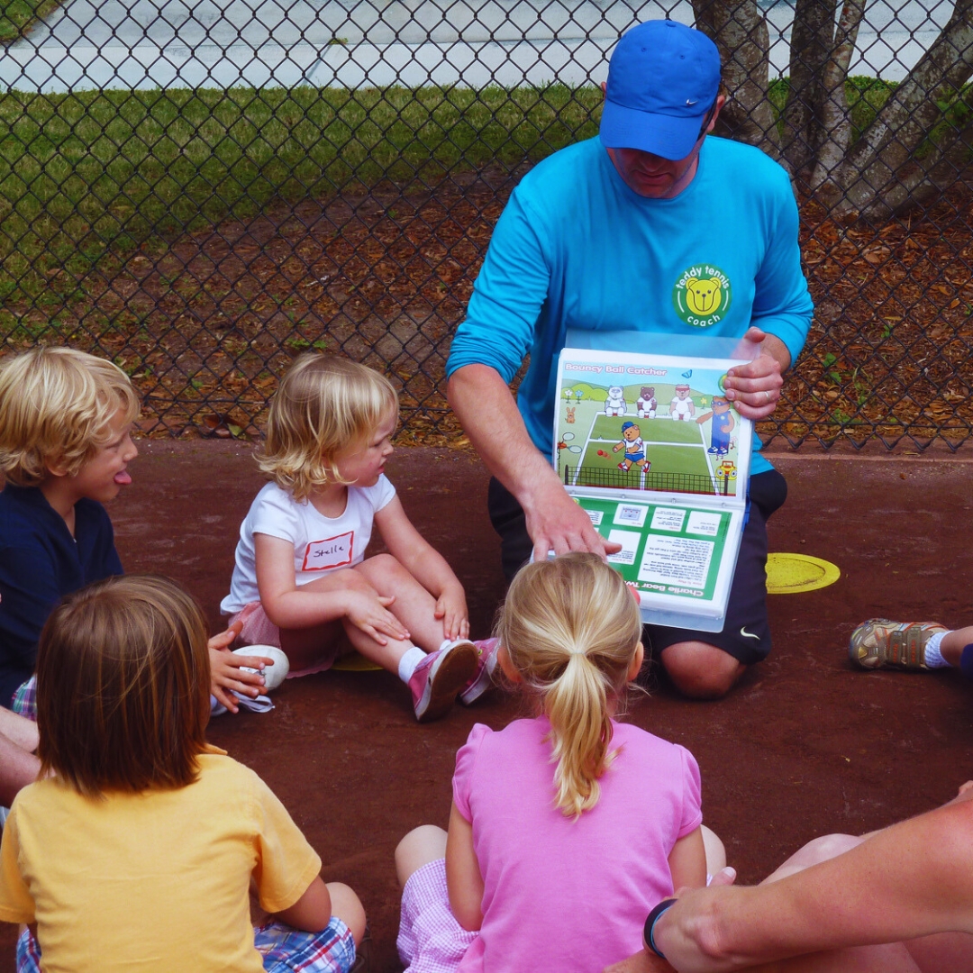 Teddy Tennis teacher shows kids the bears playing the next game
